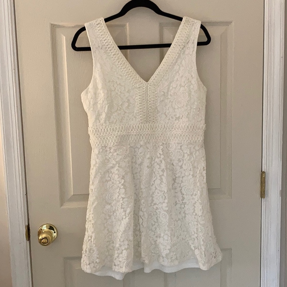 white lace mini dress, with gold detailing